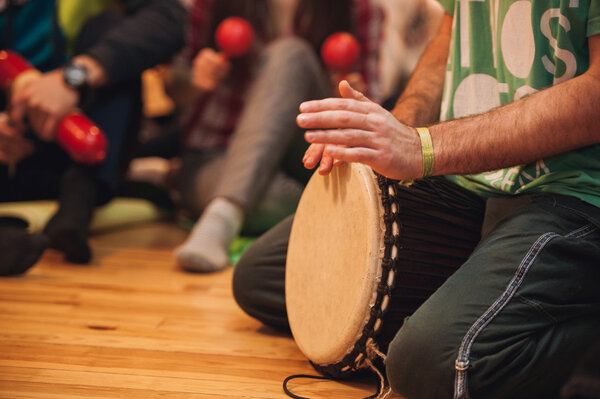 person playing on Jambe Drum no face