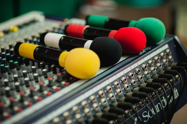 Four colored microphone on sound control panel — Zdjęcie stockowe