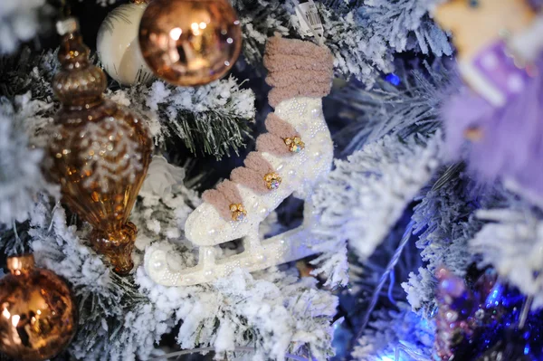 On spruce branch hanging Christmas toys in the form of skates — Stock Photo, Image