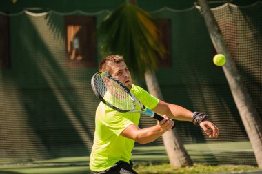 Adam Tenis parlak bir beze oynuyor.  