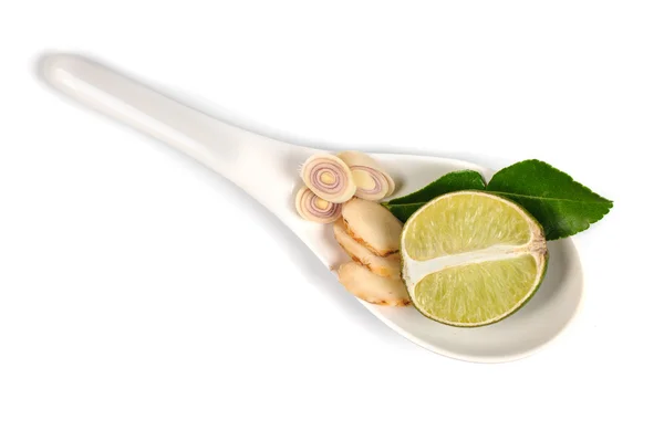 Spicy Thai food ingredients  lime,ginger, kaffir ,lemongrass in spoon isolated on white — Stock Photo, Image