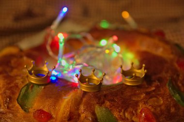 Üç kraliyet tacı ve yılbaşı ışıklarıyla süslenmiş Roscon de Reyes 'in ayrıntıları.