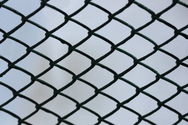 Yapısında küçük eşkenarlar oluşturan metal bir çit görüntüsü