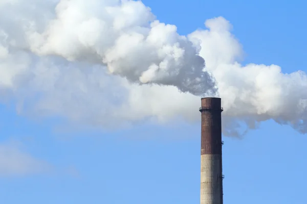 stock image Industrial smoke from chimney on blue sky