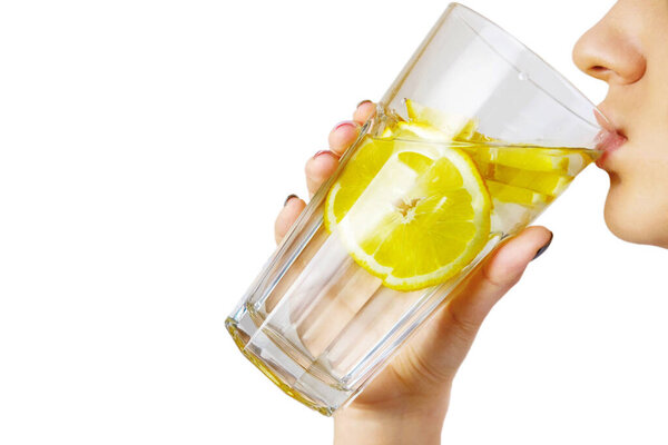 girl drinks water with lemon concept of proper nutrition