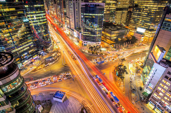 Cityscape of South Korea. Night traffic speeds through an intersection in the Gangnam district of Seoul,South Korea.
