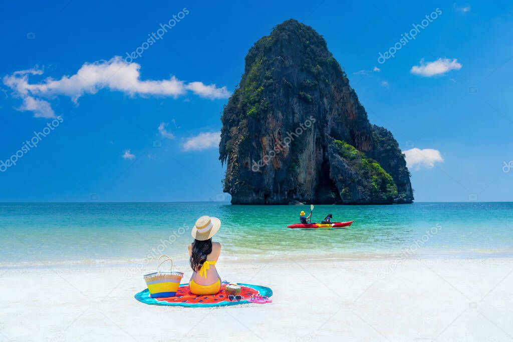 Woman in bikini relaxing at Railay, Krabi, Thailand.