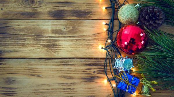 Christmas background with christmas gift,red balls, pine cones on Wooden Background. — Stock Photo, Image