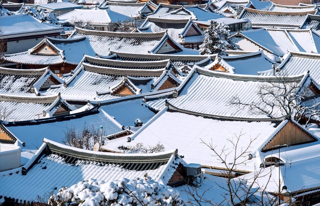 Roof of Jeonju traditional Korean village covered with snow, Jeonju Hanok village in winter, South Korea.