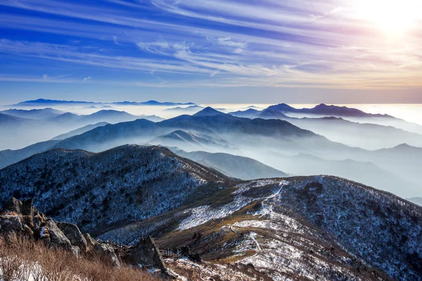 Paisaje invernal con puesta de sol y niebla en las montañas de Deogyusan, Corea del Sur . — Foto de Stock