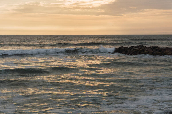 Beautiful sunset in Lima Peru, bright sky and underexposed beach, golden hour, orange sky