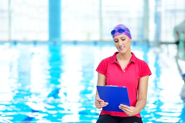 trainer writing in clipboard