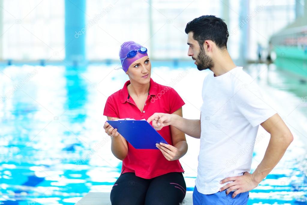 Swimmer and coach discussing