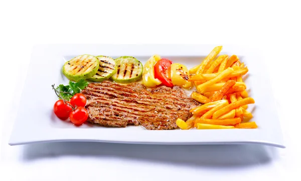 Delicious pieces of meat with French fries — Stock Photo, Image