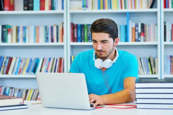 Étudiant masculin travaillant dans une bibliothèque — Photo