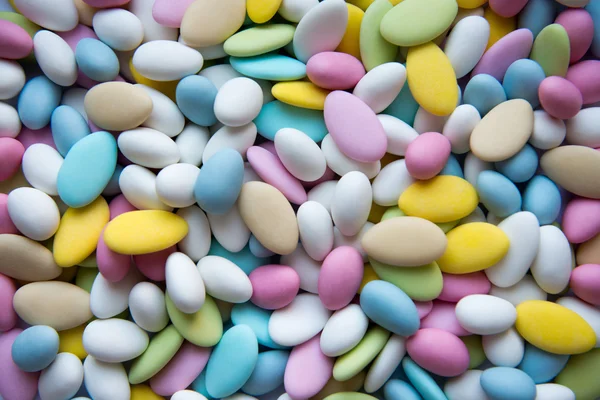 Background of sugared almonds color blue, rose, green, yellow, beige and white. — Stock Photo, Image