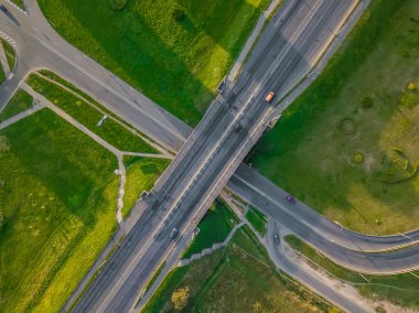 Yoldaki İHA 'nın üst görüntüsü, güneşli bir günde şehirde arabalarla köprü. Şehirdeki yollar ve köprüler