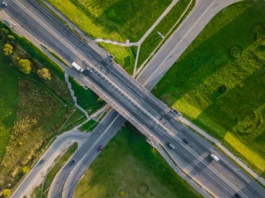 Yoldaki İHA 'nın üst görüntüsü, güneşli bir günde şehirde arabalarla köprü. Şehirdeki yollar ve köprüler