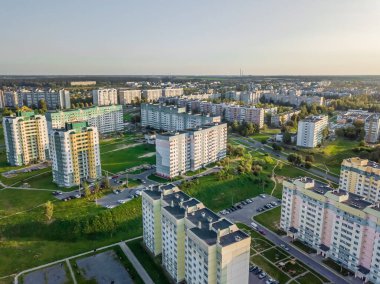 Güneşli bir günde kavşakları, yolları, evleri, binaları, parkları ve otoparkları olan şehrin hava fotoğrafçılığı