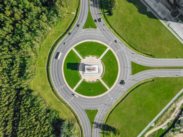 Aerial view of the ring road with a three-way fork on a Sunny summer day. City infrastructure. Beautiful top view of the ring road. Different path direction