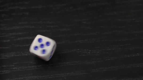 The hand turns the dice on the wooden table. Close-up — Stock Video