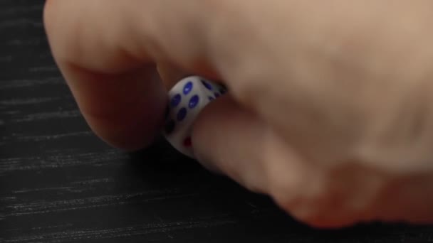 The hand turns the dice on the wooden table. Close-up — Stock Video