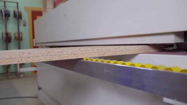 El primer plano de la parte de la parte de madera en la máquina de borde-venda. — Vídeo de stock