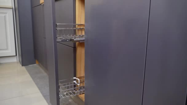 A woman opens the kitchen Cabinet for drying dishes. — Stock Video