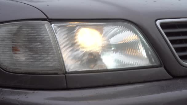 Close-up of white headlights on a car. running lights. — Stock Video