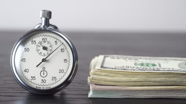 Dollars and stopwatch. Business concept of lost time and failed investments — Stock Video