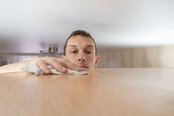 Concept Cleaning House Man Wipes Dust Tall Cabinet His House — Stock Photo, Image