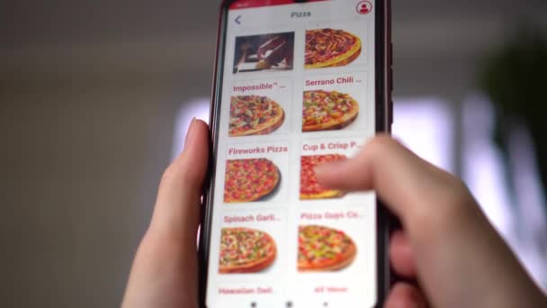 Una donna ordina cibo a casa da un negozio online, uno smartphone — Video Stock