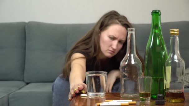 Kvinna lider av baksmälla, kastar hon smärtstillande piller i glas vatten — Stockvideo