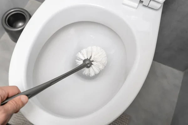 Man Hand Holds White Brush Toilet Modern Toilet — Stock Photo, Image