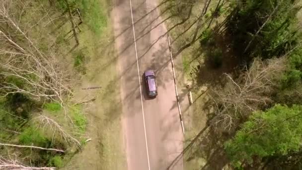 A bird's-eye view, flying over a road with a moving car, — Stock Video