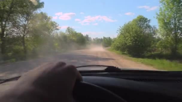 Cars race for speed on dirt gravel road, kicking up dust. camera in first person — Stock Video