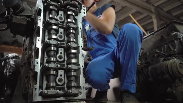 View of disassembled car engine. hands of mechanic repairing engine — Stock Video