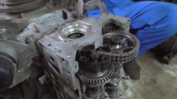 View of disassembled car engine. hands of mechanic repairing engine — Stock Video