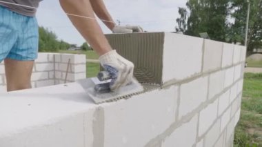 Yapıştırıcı bir sonraki blok koymak için spatula ile yapıştırıcı bileşimi veya çözeltisi uygular.