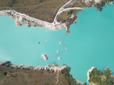 Tebeşirin çıkarılması sırasında insan yapımı dağlar oluştu. Yazın Krichev, Belarus yakınlarındaki açık havada turkuaz suyla tebeşir ocağında yapay göl.