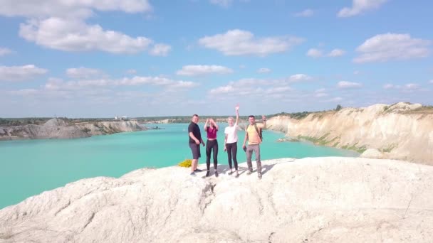 Two girls and two men are standing on the top of a mountain in chalk quarries — Stock Video