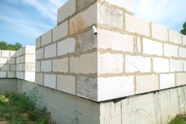 Binanın inşaatı. Beyaz bloklardan yapılmış bir konut inşaatı.
