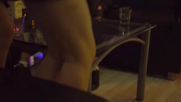 Two women get up from table in nightclub and go down stairs. Legs close-up. — Stock Video