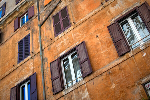 Vintage facade of apartment block in Rome, Italy, with windows and blinds