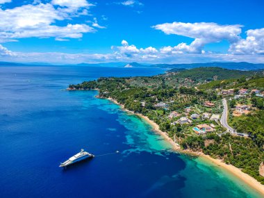 Aerial view over southern skiathos island, Greece with modern hotels and luxurious villas in Sporades, Greece, Europe clipart