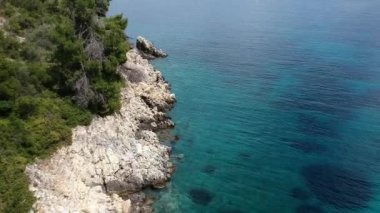 Alonissos Adası, Sporades, Yunanistan 'daki Leftos Gialos kayalık plajı üzerindeki hava manzarası