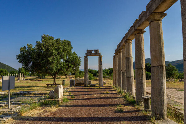 Messini, Greece - June 20 2021: Ruins in the Ancient Messene archeological site, Peloponnese, Greece. One of the best preserved ancient cities in Greece with visible remains dating back further than the 4th century BC.