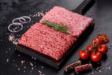 Karanlık bir arka planda taze çiğ et kıyması. Pirzola pişirme hazırlığı