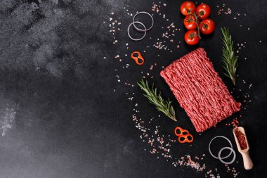 Karanlık bir arka planda taze çiğ et kıyması. Pirzola pişirme hazırlığı