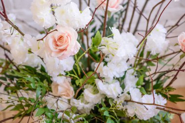 Decorations of branches with beautiful pink and white flowers in the basket against the background of a white brick wall. Home scenery